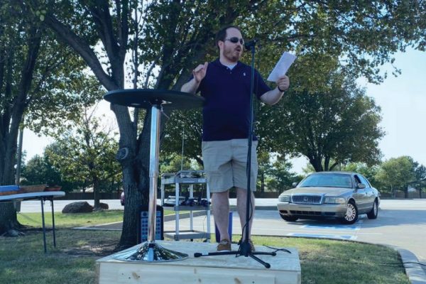 man delivering sermon outdoors